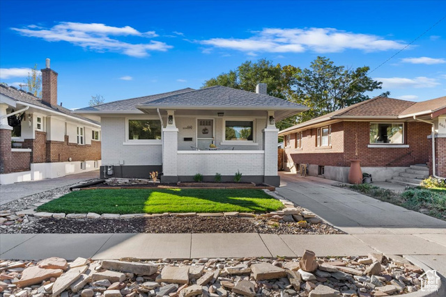 Brick bungalow home with cooling unit