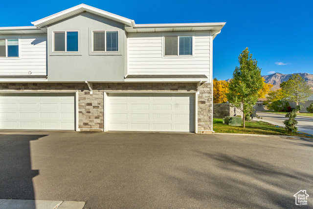 Townhome / multi-family property with a mountain view and attached two car garage