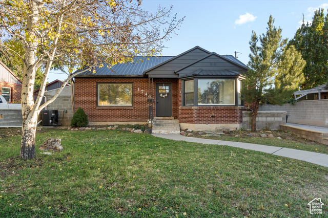 Bungalow-style home featuring a front lawn