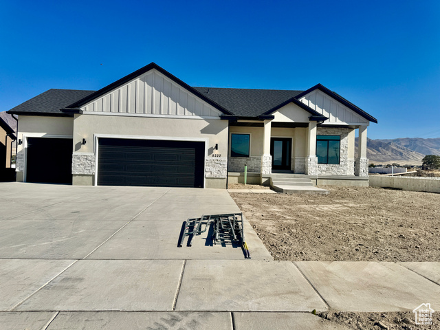 View of front facade featuring a mountain view and a garage