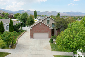 View of front of property with a mountain view and a garage