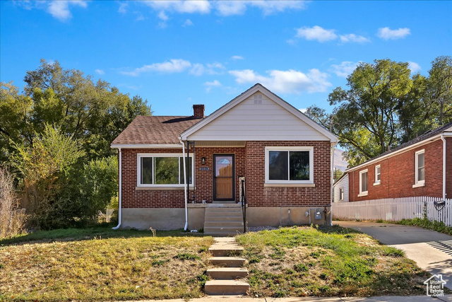 Bungalow-style home with a front yard