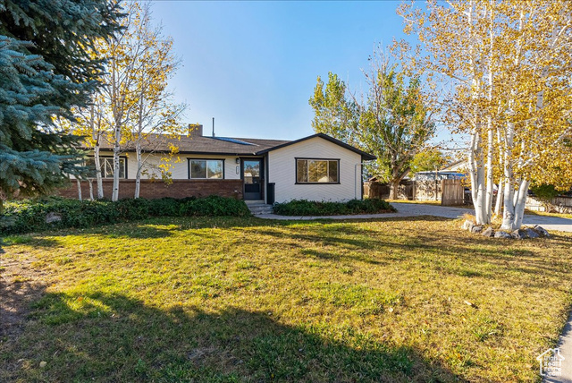 Ranch-style house featuring a front lawn