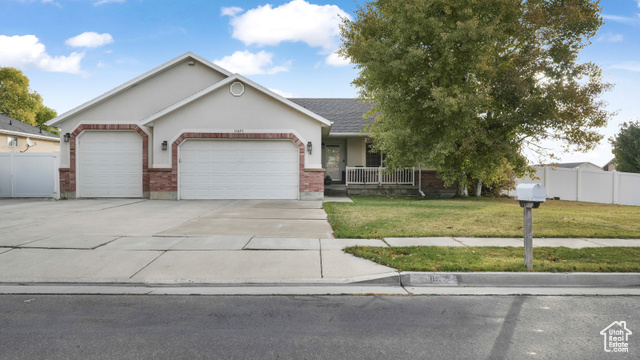 View of front of home featuring a front lawn and a garage