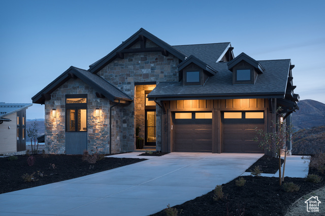 View of front of home with a garage and a mountain view