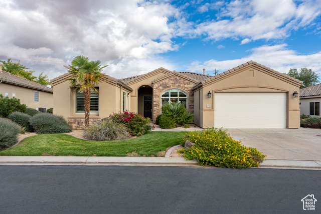 Mediterranean / spanish-style home featuring a garage