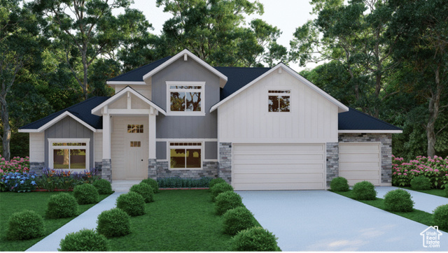 View of front of house featuring a garage and a front lawn