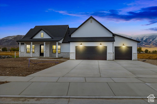 View of front of home featuring a mountain view and a garage