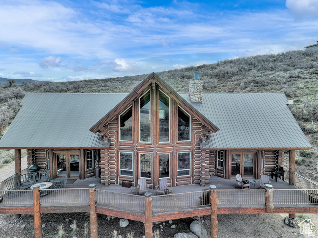 This stunning log mountain home offers incredible, breathtaking views of Mount Timpanogos and the entire Wasatch Back! The towering, vaulted tongue and groove ceilings, massive windows, the spacious, sprawling back deck and open great room concept, makes this mountain haven the perfect setup for ultimate entertaining or beautiful quiet sunset evenings! This rustic retreat features a main level luxurious master ensuite complete with gas burning stove, skylights, enormous jetted tub, walk-in closet and French doors that open out onto the deck. The open loft is used as a study, but could also function as additional sleeping quarters. Imagine working from home in this dreamy retreat! The downstairs offers the same unbelievable views with a cozy, comfortable family room area, full bathroom and two large bedrooms. Offered fully furnished, turnkey with kitchenware and linens! Gorgeous landscaped yard with paved driveway. Dual water heaters, brand new AC and Water Science filtration system. The craftsmanship and meticulous style of this cabin perfectly compliments a true mountain lifestyle! Surrounded by recreational activities at your fingertips including, boating on nearby lakes, world-class golf, phenomenal skiing, epic snowmobiling, hunting, hiking, access to Uinta National Forest, mountain biking, ATV-ing and more! Located only 5 minutes from Timber Lakes entrance. Only 55 minutes to the SLC airport and just minutes from all the wonderful amenities of the Heber Valley & Park City! YEAR ROUND access!