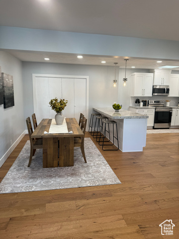 Dining area with light hardwood / wood-style flooring