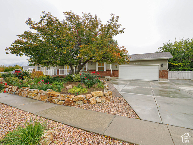 This beautifully renovated home on a spacious .50-acre lot in South Jordan offers the perfect blend of modern upgrades, charming outdoor space, and room for hobbies or multi-generational living. The heart of the home is the gourmet kitchen, with brand-new cabinets, sleek countertops, a farmhouse sink, and a huge central island-ideal for cooking, entertaining, and gathering. Fresh paint, new light fixtures, updated windows with plantation shutters, and updated flooring throughout enhance the entire home. Other features include a new Lennox furnace and central air installed in 2020, complete with a humidifier, as well as a new roof installed in 2019.  The home offers a separate basement entrance with a second kitchen and laundry downstairs, perfect for hosting guests or creating a mother-in-law apartment. Outdoors, the fully fenced, park-like yard is a true highlight, with a covered back deck, treehouses, fruit trees, grapes, and berry bushes, along with a large garden area-plenty of room for growing your own produce, or even adding a pool. For those seeking a retreat space, the insulated Man Cave/She Shed in the back features electricity and hardwood floors, providing an ideal area for hobbies, work, or relaxation. There is also plenty of parking, including an RV area with power.  Don't miss out on this rare find-schedule a showing today and see everything this home has to offer!