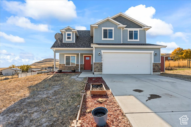 Craftsman house with a garage and a mountain view