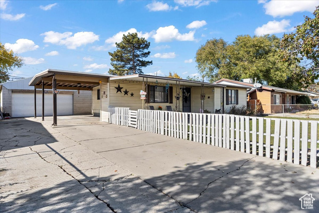 Ranch-style house with a large detached garage.