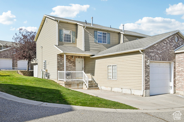 View of front of home featuring a front lawn and a garage