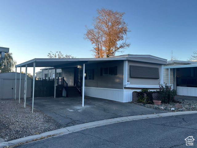 Exterior space featuring a shed and a carport