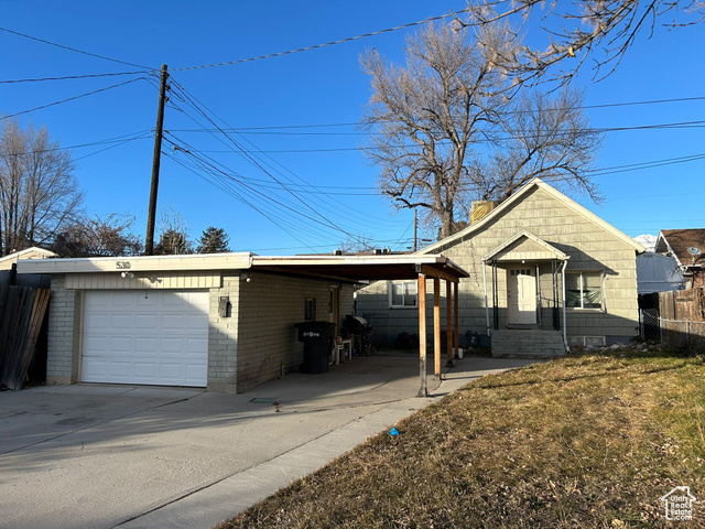 View of front of property featuring a carport