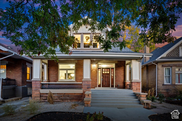 View of front facade with porch and xeriscaped front lawn. Sound dampening windows on front facade