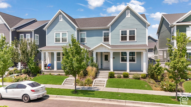 View of front of house with a front lawn and a porch