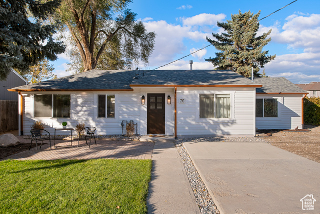 Ranch-style house featuring a patio area and a front lawn