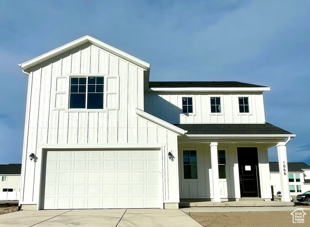 Modern inspired farmhouse with covered porch and a garage