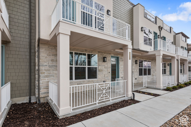 Exterior space featuring a porch and a balcony