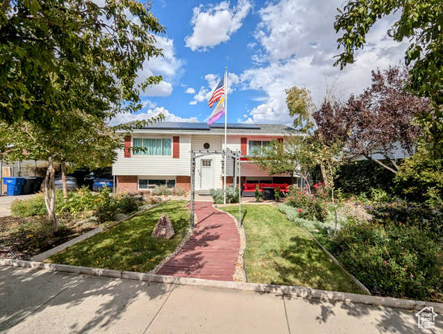 Front facing south.  Flagpole, pergola, sitting area, solar panels (owned)