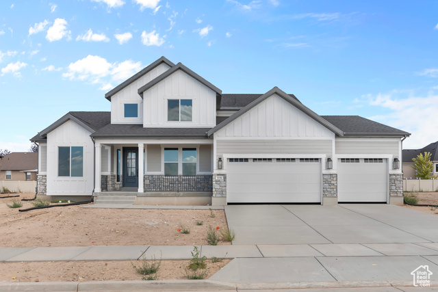 View of front of home with a garage and a porch