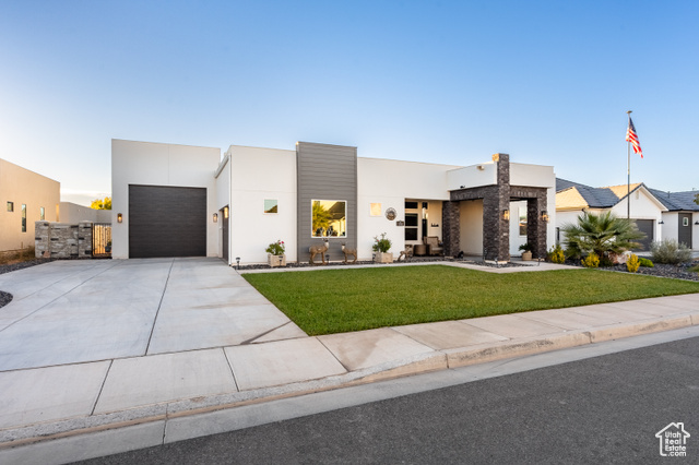 Contemporary home featuring a front lawn and a garage