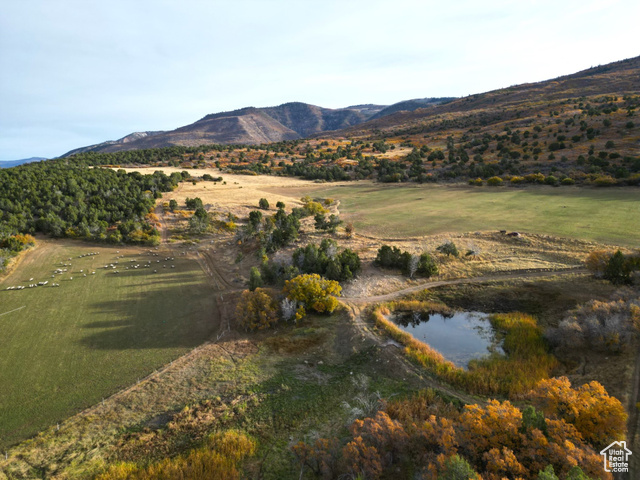 View of mountain feature featuring a water view and a rural view