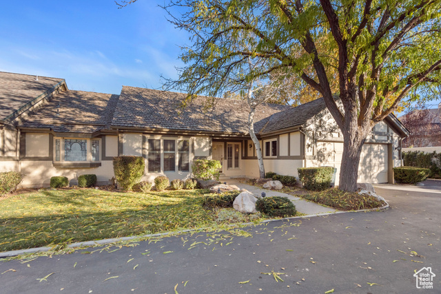 View of front of house featuring a front lawn and a garage