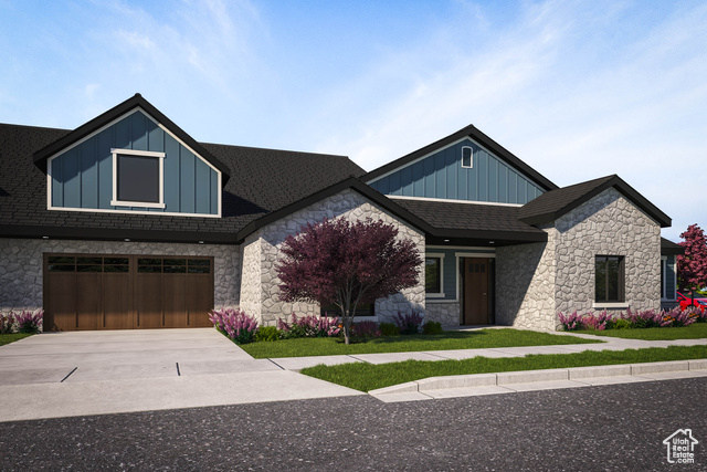 Craftsman-style house featuring a garage and a front lawn