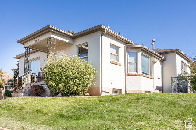 View of side of home featuring a lawn