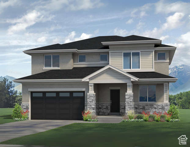 Prairie-style house featuring a garage and a front yard