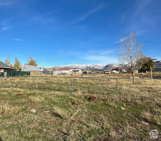 View of yard with a rural view and a mountain view