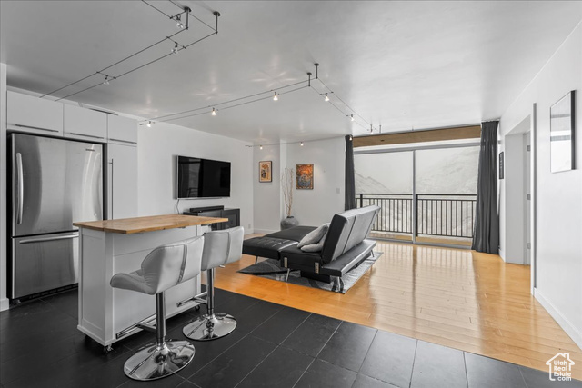 Living room with dark wood-type flooring