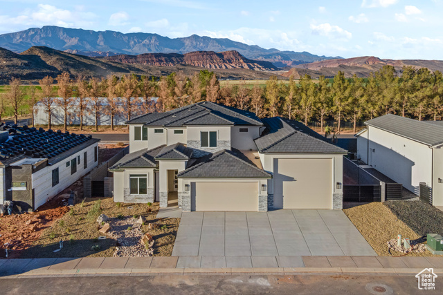 View of front facade featuring a mountain view and a garage