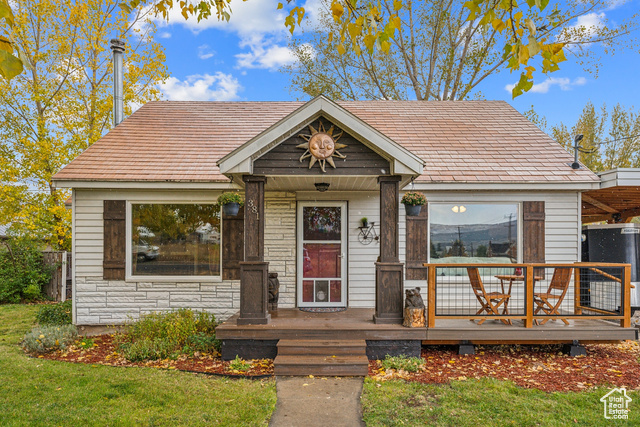 Nestled in the heart of Heber City, this charming bungalow has an enviable blend of modern updates and rustic charm. Featuring a cozy single bedroom complemented by a versatile, spacious loft perfect for a large bedroom, with storage area and closet space or bunkroom.  Step into the expansive living room, where you'll find a welcoming wood-burning stove that sets the perfect ambiance for relaxing evenings. The updated kitchen boasts sleek new countertops and a stylish modern range hood, marrying functionality with aesthetics. Recent upgrades include new lighting, countertops, stainless steel appliances, a spacious front porch to enjoy the outdoor atmosphere, a fresh paint job, furnace, hot water heater, crown molding, disposal, and baseboards. Off the kitchen is the laundry area with built-in cabinets, creating a convenient pantry space and a door to access the yard. A pocket door can keep the area private from the kitchen space. Outside, the property offers a wonderful 18x20 shop that includes power and an extra loft area for amazing storage, and a carport, ensuring your vehicle remains protected during winter months. Just a 15-minute drive to the Deer Valley Gondola and all the attractions Park City has to offer, and within walking distance to local restaurants and entertainment, this home is an ideal haven for both peace and convenience. The yard features large mature trees, fruit trees, and a patio area. There is also a covered wood storage shed to complete this amazing home.