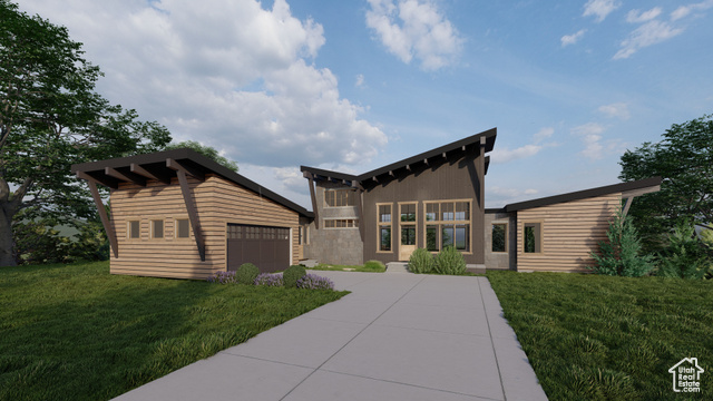 View of front facade featuring a garage and a front yard