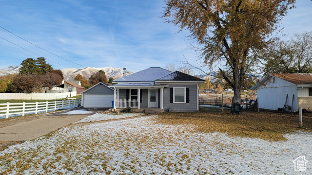 View of front facade with a mountain view and covered porch