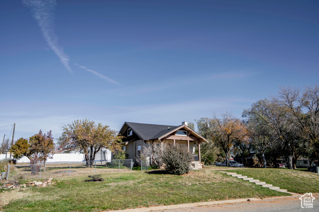 View of side of home featuring a lawn and central air condition unit