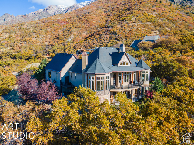 Back of house featuring a mountain view and a balcony