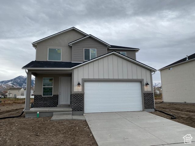 View of front of property featuring a mountain view and a garage