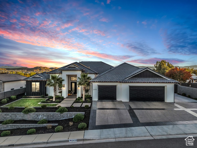 View of front of property with a mountain view and a garage