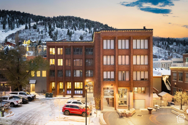 Snow covered property with a mountain view