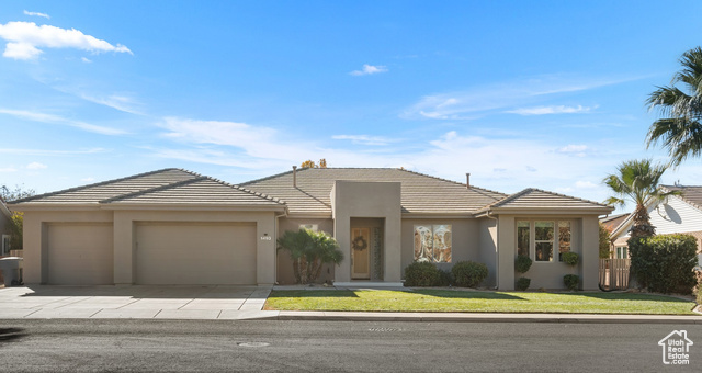 View of front of home featuring a front yard and a garage