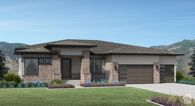 Prairie-style house with a mountain view, a front yard, and a garage