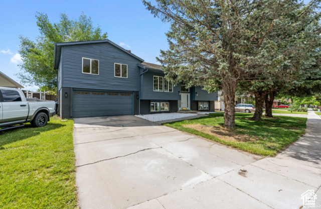 View of front of home featuring a garage and a front yard