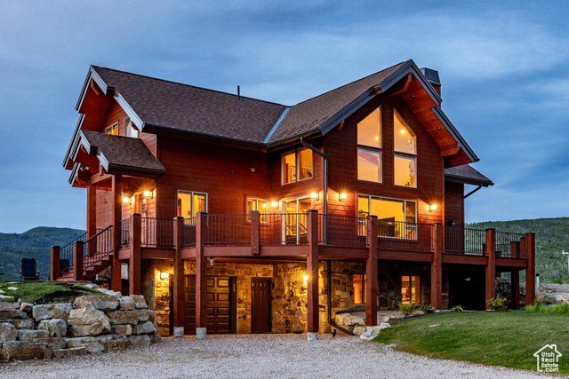 View of front facade with a mountain view and a front lawn