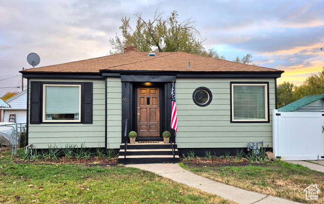 Bungalow-style home with a lawn