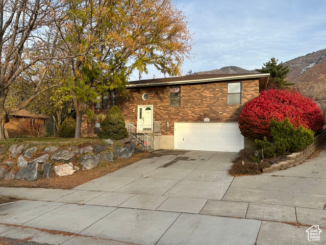 View of front facade with a mountain view and a garage